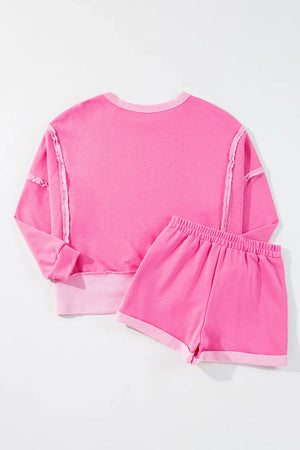 Fuchsia pink cotton loungewear set with contrast trim and ruffled seams.