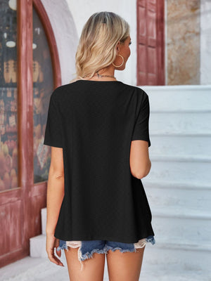 Black perforated short sleeve jacket with a shawl collar.