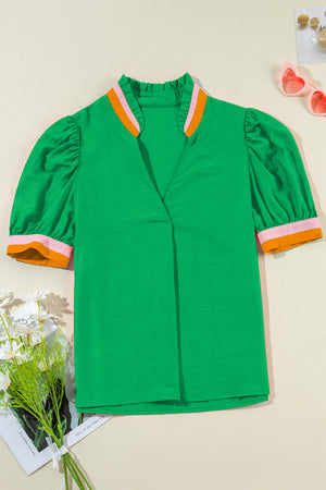 Green colorblock puff sleeve blouse with ruffled collar and contrast cuffs.