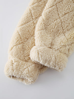 Textured teddy zip-up jacket in tan with diamond quilting and fuzzy cuffs.