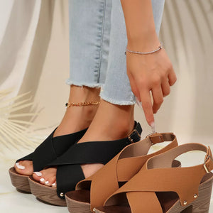 Crisscross high heel sandals in black and brown with stud details and adjustable straps.