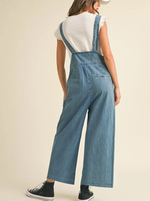 Vintage denim wide leg overalls with adjustable straps and button details.