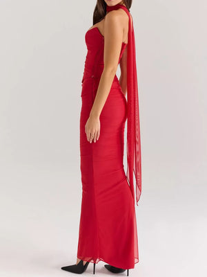 Red sweetheart tube top and flowy maxi skirt set with sheer cape detail.