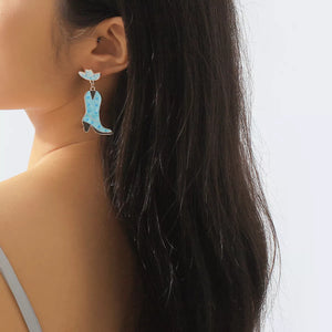 Blue cowboy boot dangle earrings with white polka dots and a matching hat detail.