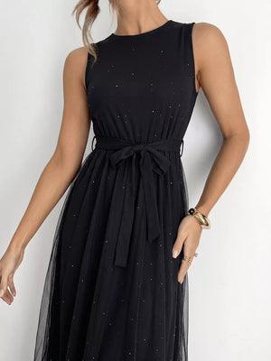 Black tulle midi dress with scattered glitter and self-tie belt.