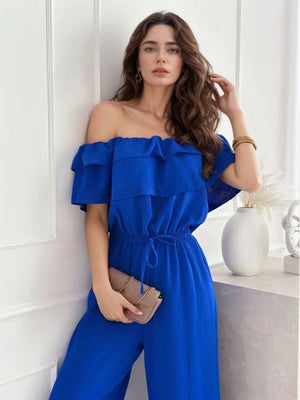 Royal blue off-the-shoulder ruffle jumpsuit with drawstring waist and wide legs.