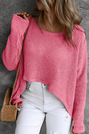 Asymmetric slouch knit top in strawberry acrylic with a relaxed fit and uneven hem.