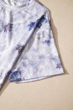 Tunic tee with purple and white tie dye and blue leaf print, crew neck, short sleeves.