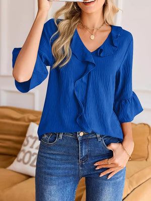 Blue maternity shirt with V-neck and cascading ruffles, 3/4 bell sleeves.