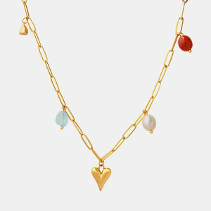 Gold paperclip chain necklace with heart charm and colorful bead accents