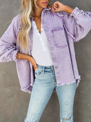 Lavender frayed denim overshirt jacket with button front and chest pockets.