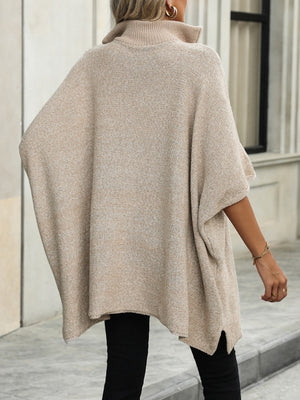 Apricot knit zip-neck poncho with asymmetrical hem and mock neck.