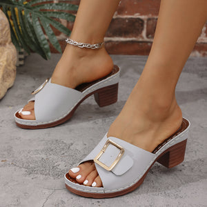 Gray block heel sandals with buckle detail and open toe.