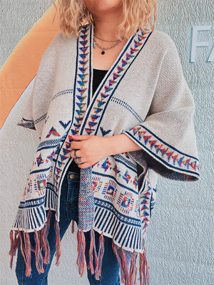 Apricot kimono with embroidered trim and colorful fringe hem, open front, wide sleeves.