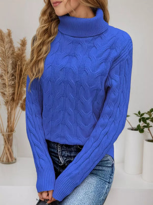 Royal blue cable-knit turtleneck sweater with long sleeves and ribbed cuffs.