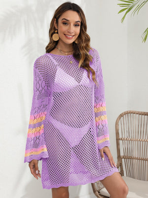 Purple crochet cover-up with bell sleeves and striped cuffs, worn over a bikini.
