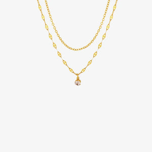 Gold layered necklace with delicate chain and single clear stone pendant