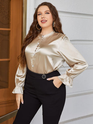 Gold satin blouse with mandarin collar, ruffles, and button front.