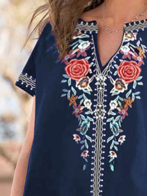 Navy blue blouse with floral embroidery and notched neckline