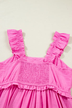 Pink ruffled sleeveless maxi dress with smocked bodice and tiered hem.