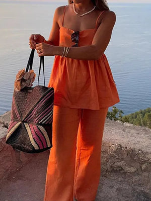 Orange square neck cami and wide-leg pants set with spaghetti straps and a flowy top.