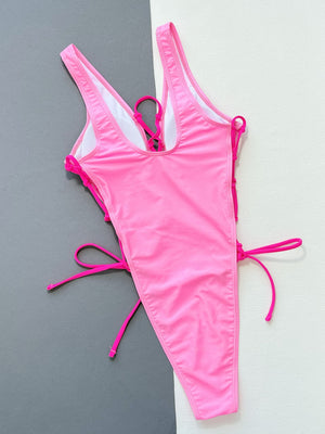 Pink lace-up plunge one-piece swimsuit with adjustable side ties.