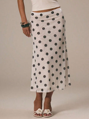 Classic polka dot midi skirt in white with black dots, featuring a sheer overlay and a-line cut.