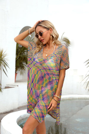Open-knit caftan with slit hem in a rainbow multicolor pattern, V-neck, short sleeves.