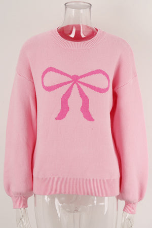 Blush pink acrylic sweater with a graphic pink bow intarsia pattern and crew neck.
