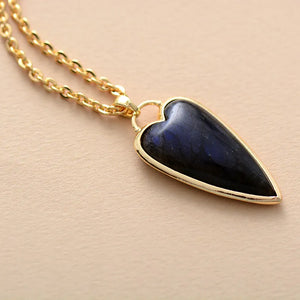 Gold chain necklace with a dark blue labradorite heart pendant