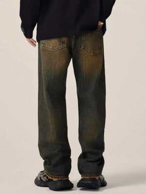 Men's relaxed fit jeans in vintage wash cotton with distressed details.