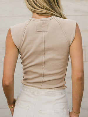 Tan ribbed knit tank top with structured shoulders and a back seam detail.