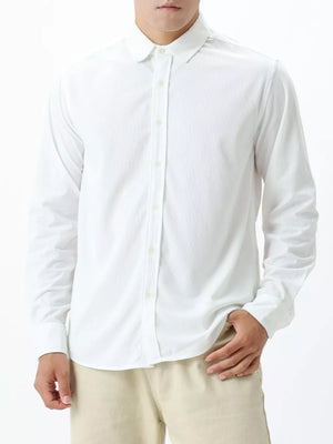White long sleeve buttoned shirt with subtle texture and spread collar.