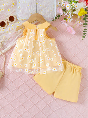 Yellow daisy print baby set with sheer overlay top and matching shorts.