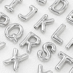 Silver initial pendant charms in various letters, including Q, R, S, T, J, K, L, D, X, and A.