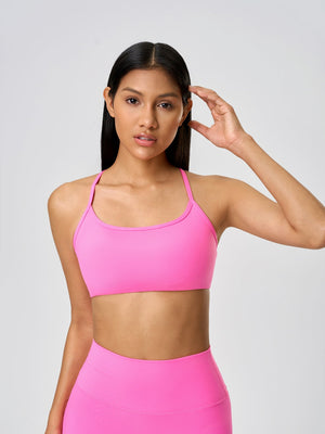 Strappy back active crop top in fuchsia pink with a scoop neckline.