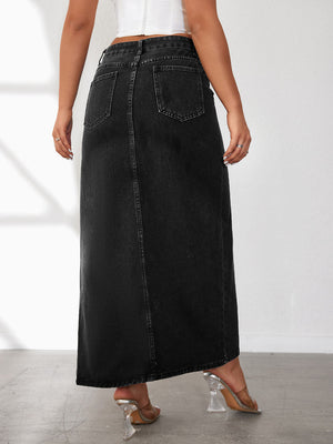 Black washed denim maxi skirt with a high slit, featuring back pockets and a center seam.