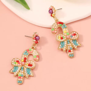 Festive candy cane bow earrings with colorful beads and pearls.