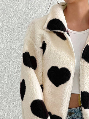 Heart print sherpa zip-up jacket with a collared neckline and full zip closure.