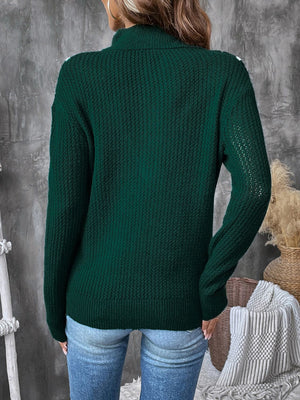Dark green textured knit sweater with chevron trim and zip neck.