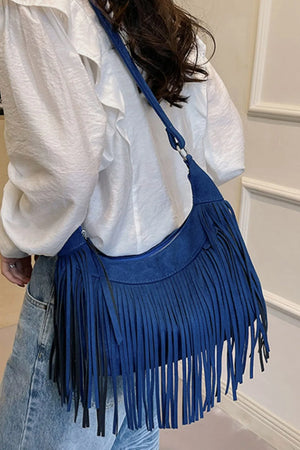 Bohemian suede crescent crossbody bag with fringe detail in navy.