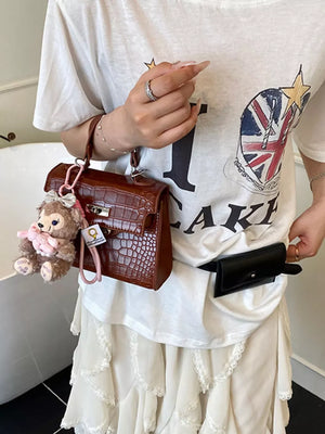 Crocodile-embossed Medium Handbag in Brown, model styling view