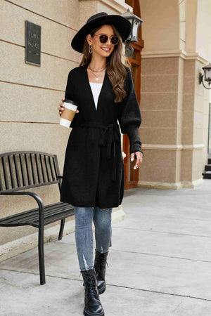 Black knit cardigan with puffed sleeves and tie waist, acrylic fabric