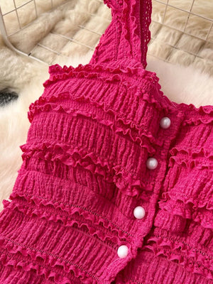 Textured rose red ruffled crop top with pearl buttons.