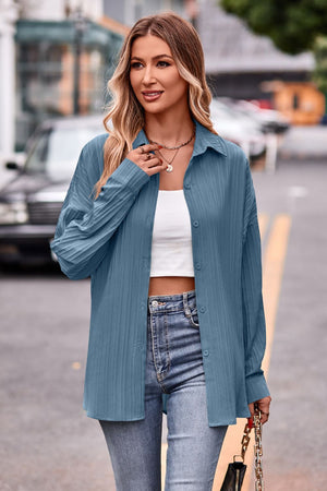 Sky blue textured oversized shirt with button front and long sleeves.