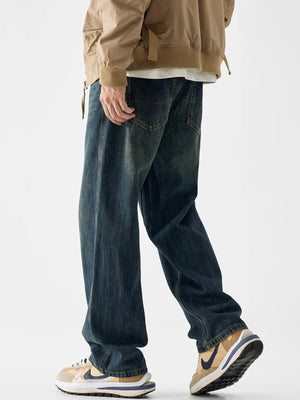 Loose fit blue cotton denim jeans with vintage wash and visible back pockets.