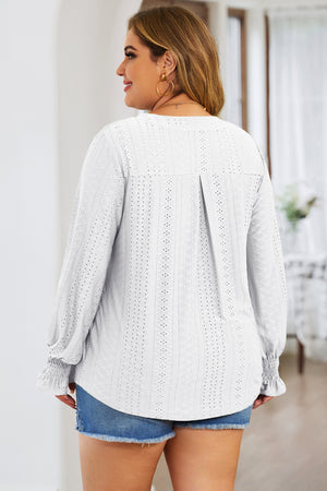 White textured blouse with shirred cuffs and a slit neckline.