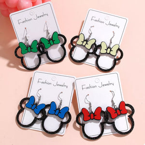 Mickey Mouse inspired bow drop earrings in yellow, lime, red, green, and blue acrylic with black glitter outline.
