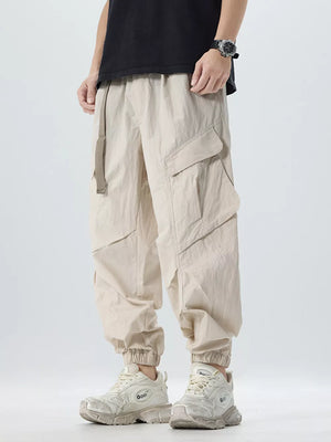 Oversized khaki cargo pants with adjustable belt and multiple pockets.