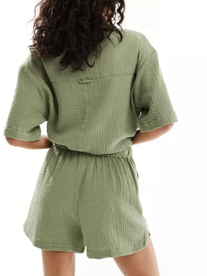 Army green crinkle cotton two-piece pajama set with short sleeves and elastic waist shorts.